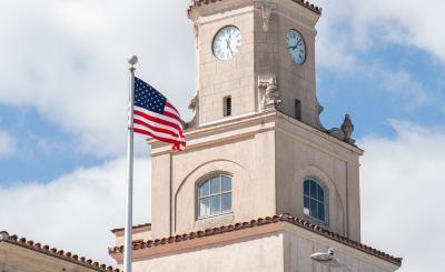 American flag stands next to City Hall 